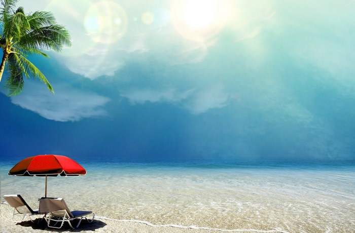 Beach with umbrella and lounge chairs