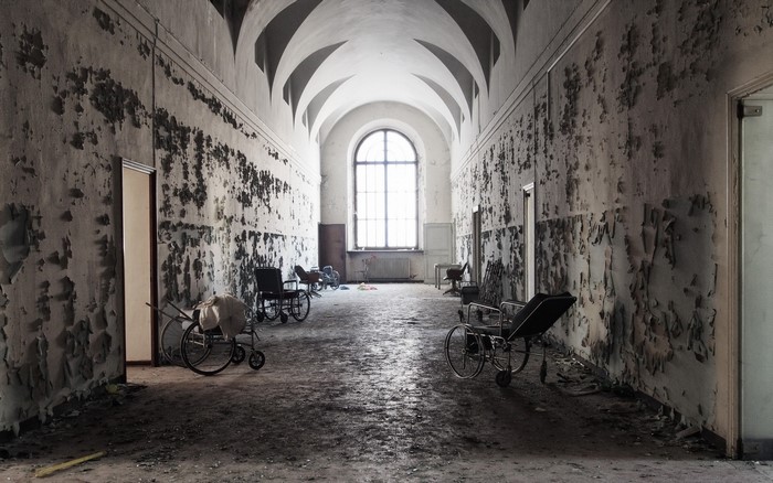 Abandoned hallway with wheelchairs and arched ceiling