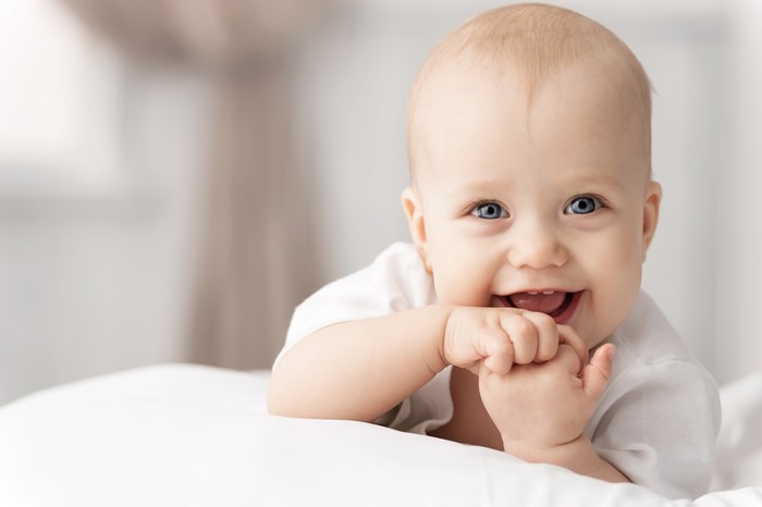 Baby smiling and looking at the camera