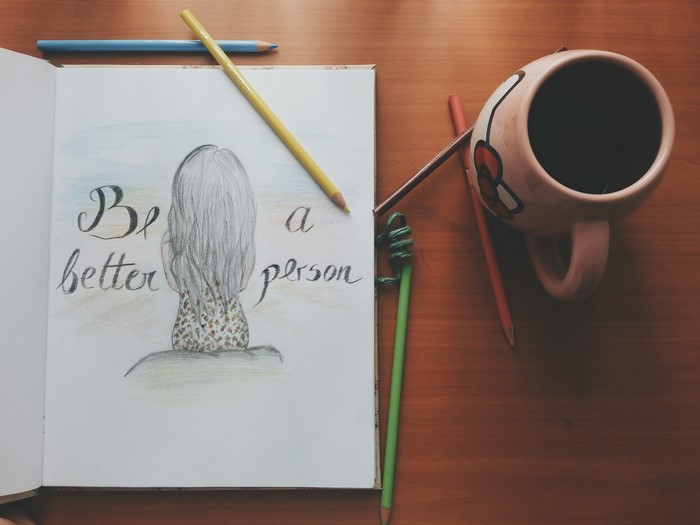 Drawing of a girl with text and art supplies