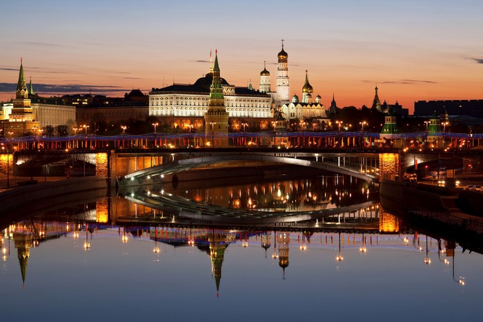 Moscow Kremlin and bridges over river at night