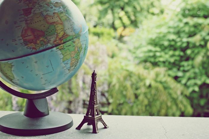 Globe and Eiffel Tower miniature with greenery background