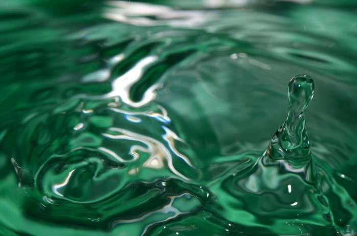 Green water splash with a drop