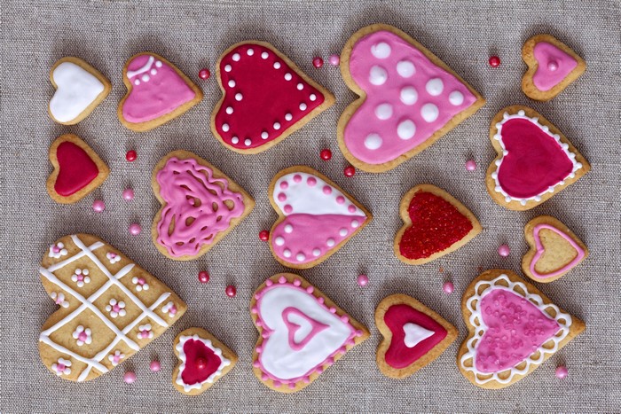 Heart-shaped cookies with colorful icing and sprinkles