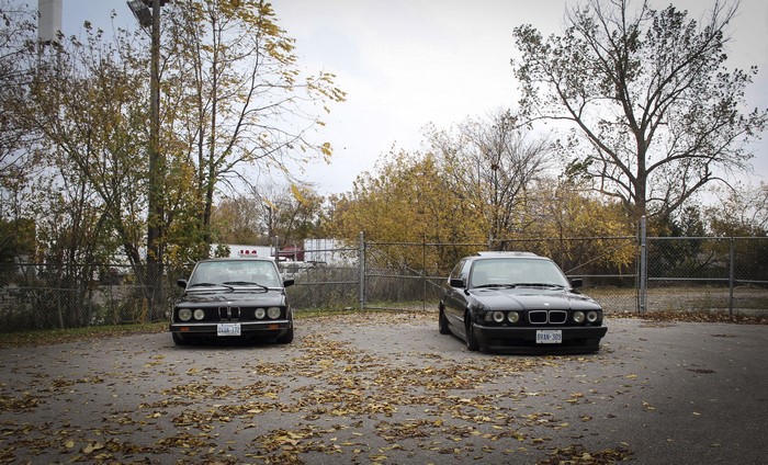 Two BMW E28 and E34 cars in autumn