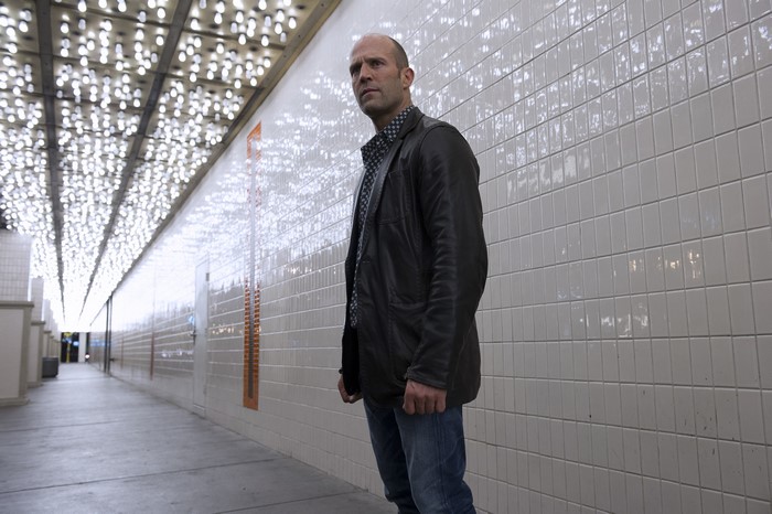 Jason Statham in a leather jacket