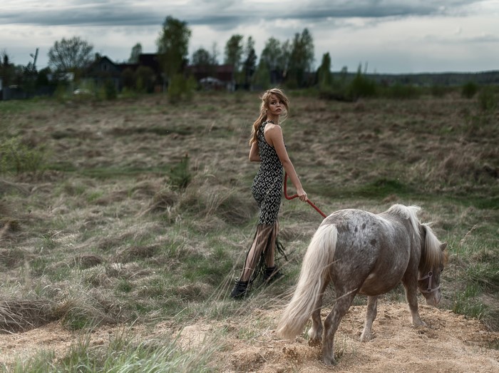 Tatiana Mercalova with a horse in a field