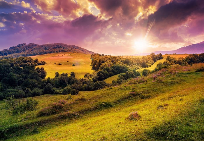 Sunset over rolling hills and fields