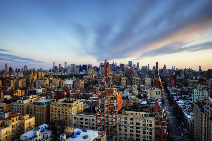 New York City skyline at dusk with clouds