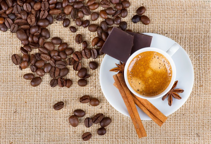 Coffee beans, chocolate, cinnamon, and star anise with espresso
