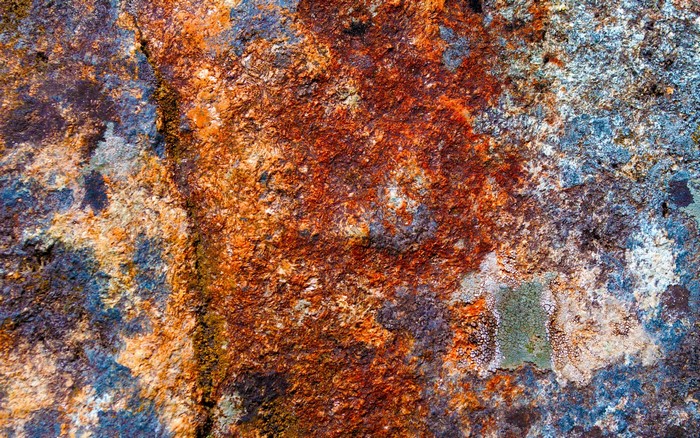 Close-up of rusty and weathered rock surface texture