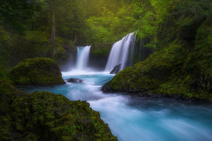Waterfalls and river in a green forest