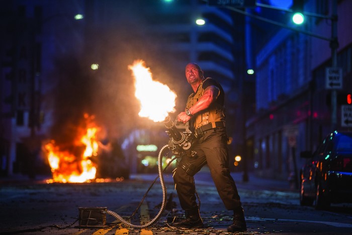 Dwayne Johnson firing a minigun in Furious 7