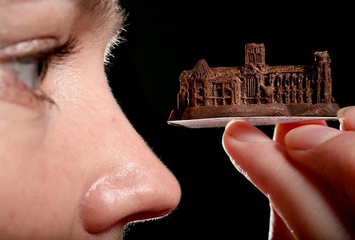 Person holding a miniature chocolate castle