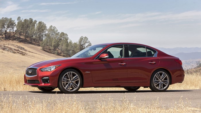 Red Infiniti Q50 Sedan on a Dry Hillside
