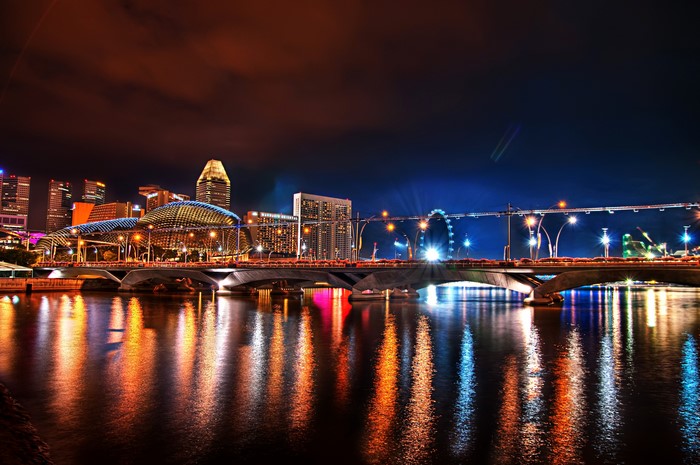 Singapore skyline with bridge and river at night