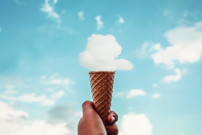 Ice cream cone with cloud on blue sky