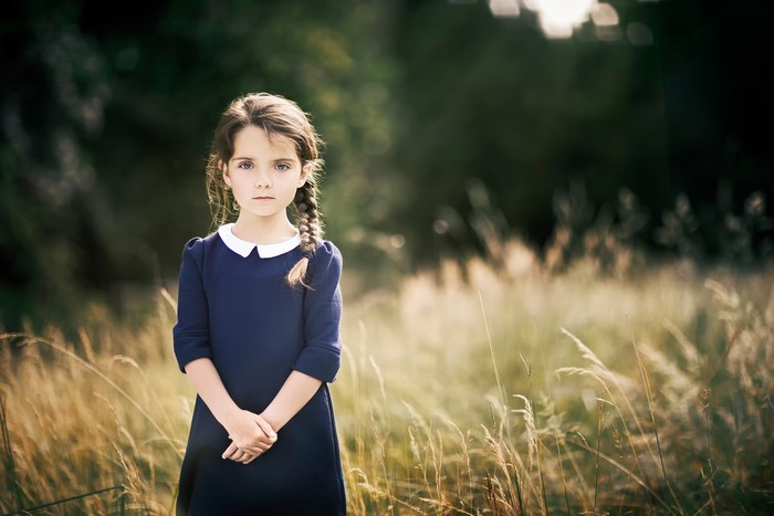 Young girl with braid in a field