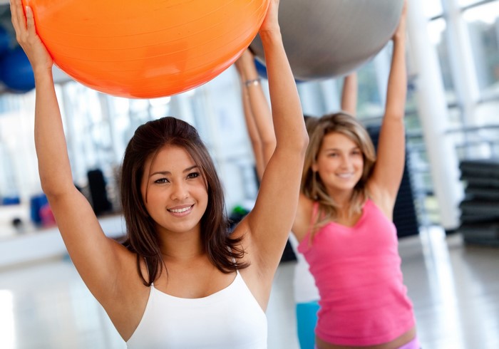 Two women exercising with fitness balls