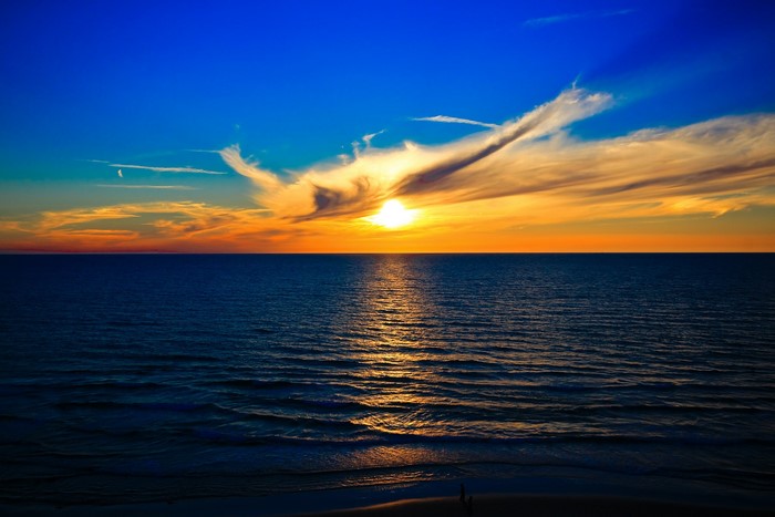 Sunset over the ocean with dramatic clouds