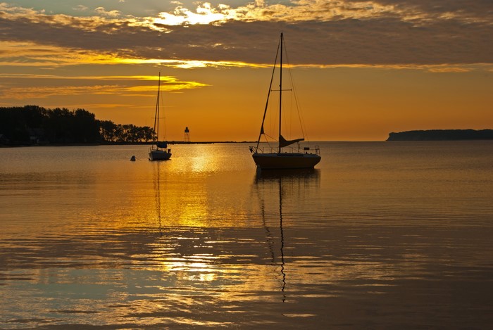 Sailboats on a lake at sunrise