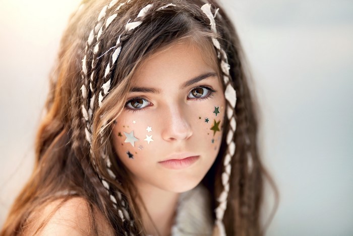Young Girl with Braided Hair and Star Stickers
