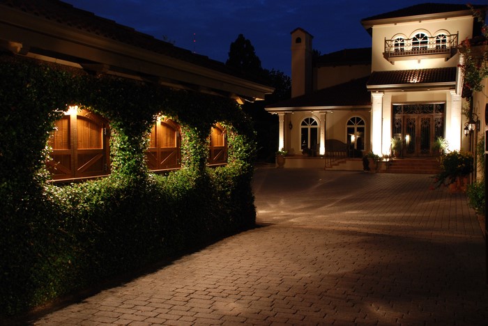 Luxury Mansion Entrance at Night with Exterior Lighting