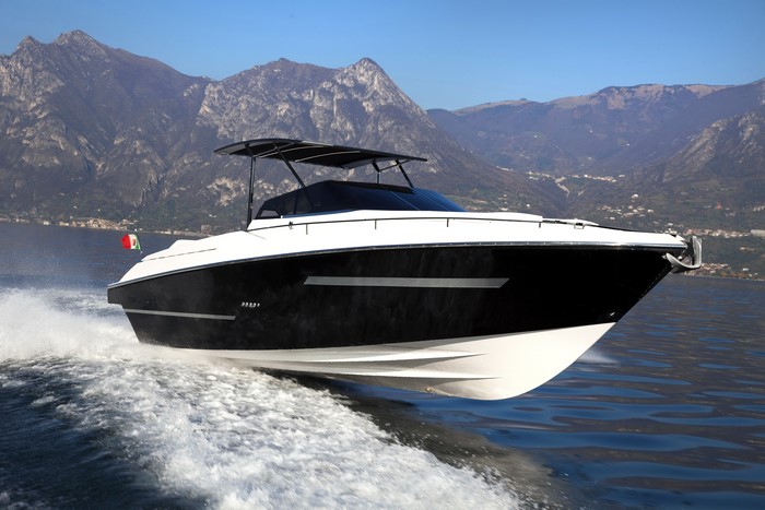 Black and white yacht on a lake with mountains