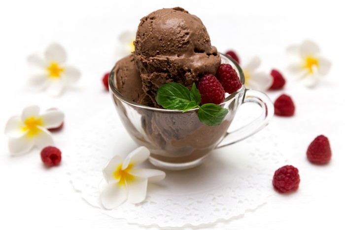 Chocolate ice cream with raspberries and flowers