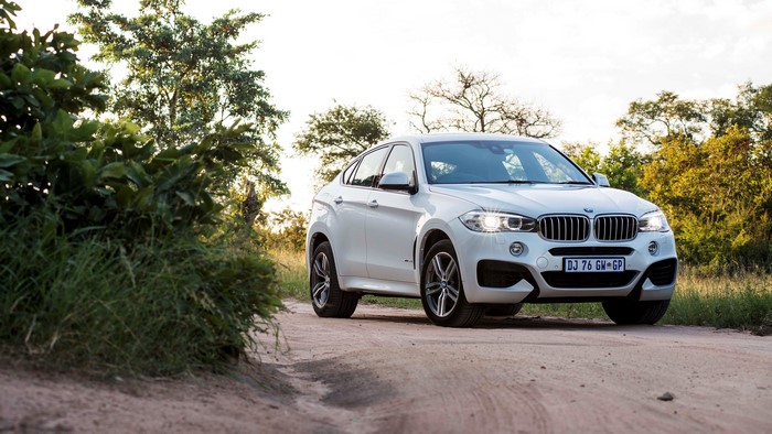 White BMW X6 xDrive on a dirt road