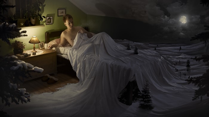 Man in Bed with Snowy Landscape