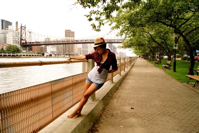 Woman in Hat by Bridge in Park