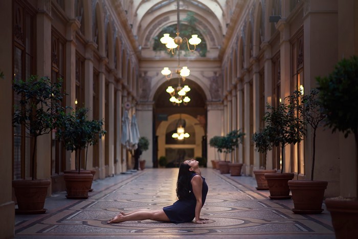 Woman in Cobra Pose in an Ornate Hallway