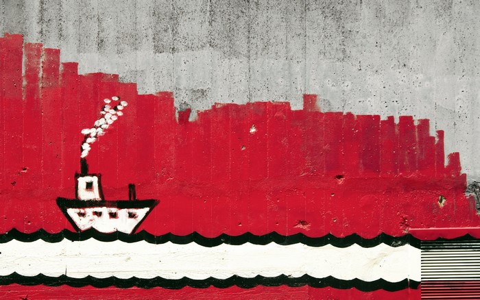 Graffiti of a ship on a concrete wall