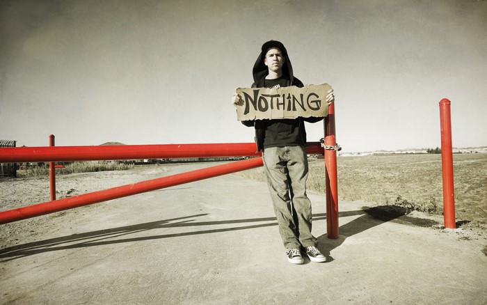 Man holding a sign that says nothing