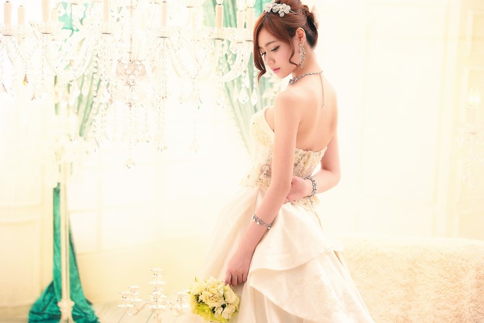 Asian bride in a wedding dress with bouquet