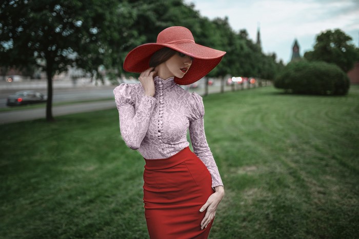 Woman in red hat and skirt with lace top