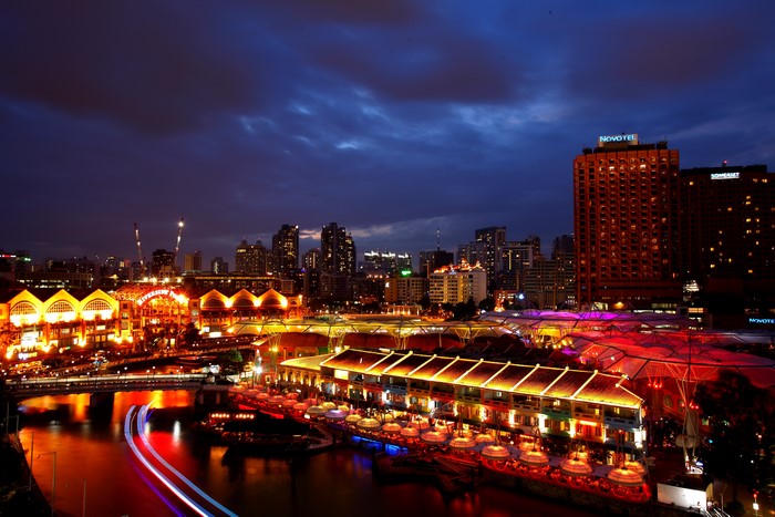 Singapore skyline at night with river and buildings