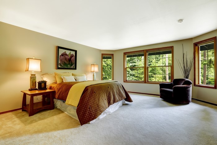 Bedroom with bed, lamps, and armchair