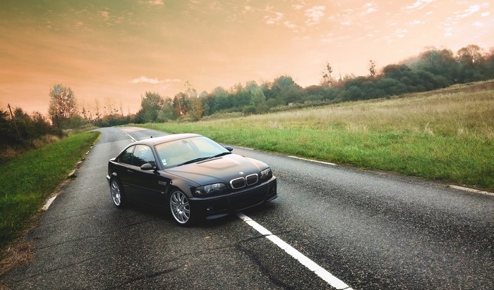 Black BMW E46 M3 on a country road
