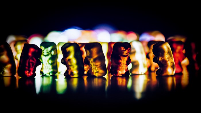 Gummy bears illuminated with colorful lights