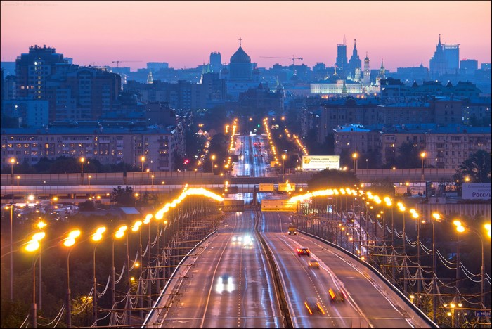 Moscow cityscape with illuminated highway at dusk
