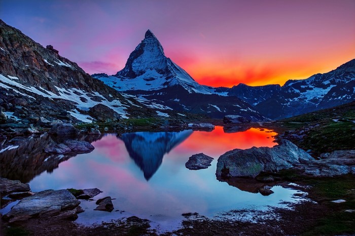 Matterhorn mountain reflected in a lake at sunset