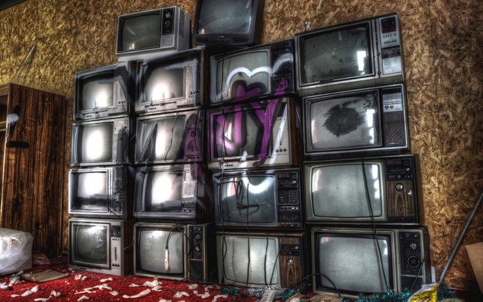 Stack of old TVs with graffiti