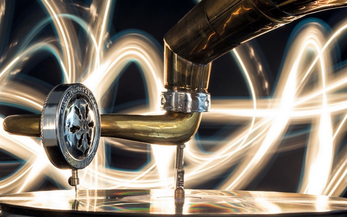 Gramophone needle on a record with light trails