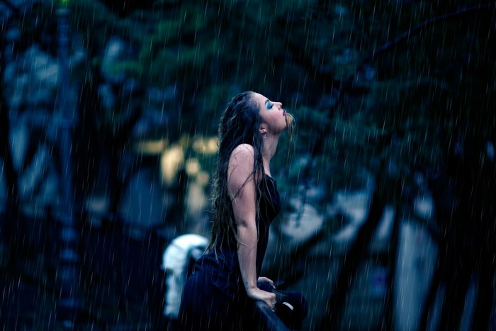 Brunette girl in the rain at night