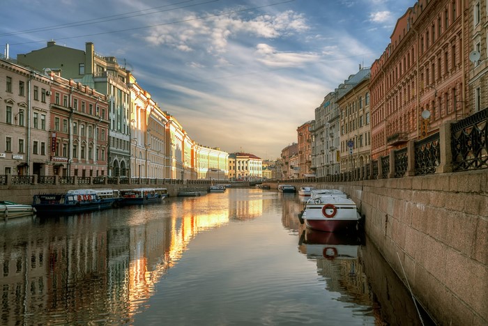 Canal in St. Petersburg with boats and buildings