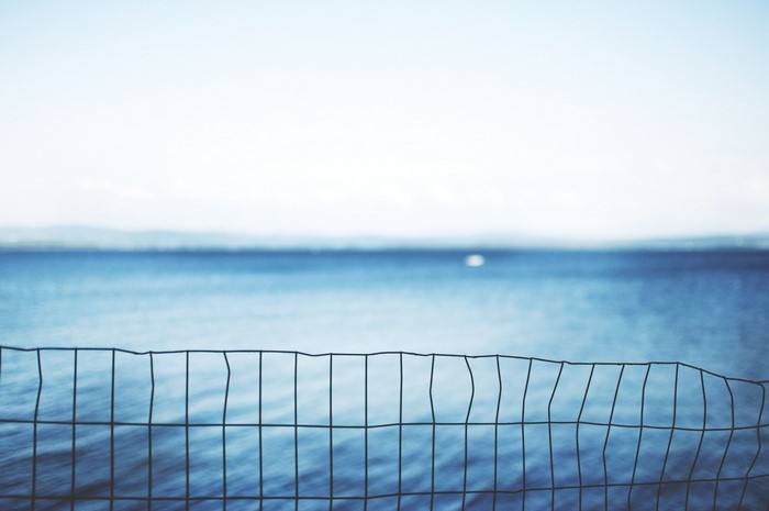 Wire fence in front of the sea and sky