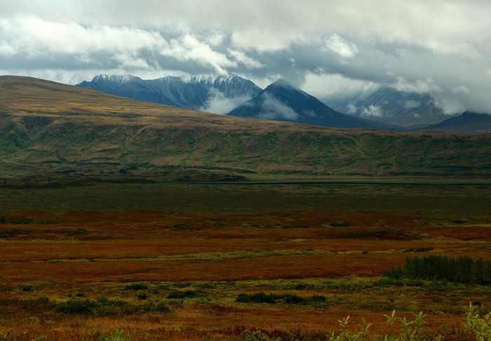 Mountains and clouds over autumn tundra