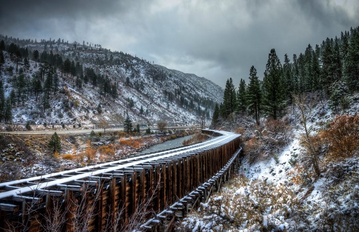 Snowy mountain landscape with railroad bridge